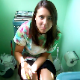 A girl is video-recorded while sitting on a toilet. Her friend accuses her of pooping, but she says she is only peeing. No bodily function sounds, and she is too shy to wipe on camera.